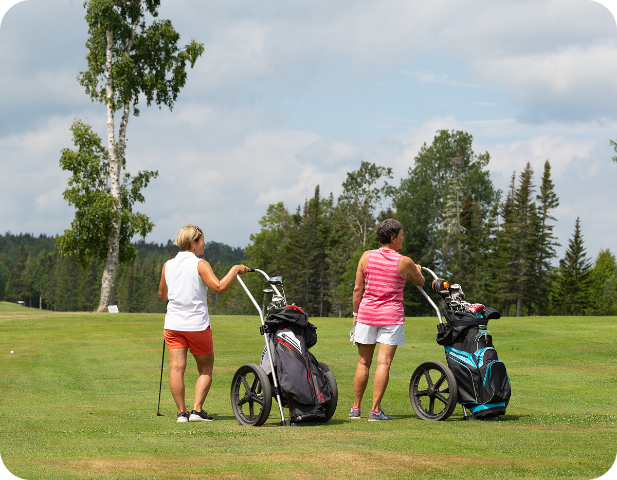 Two women with golf carts