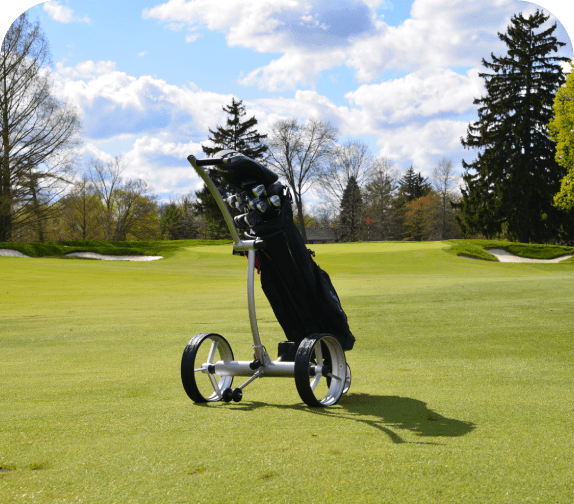 Golf bag on push cart on course.
